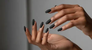 Matte black nails on dark skin with coffin shape fall manicure