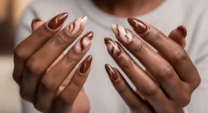 Mocha marble nails on dark skin with brown swirl design