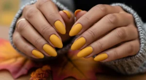 Mustard yellow fall nails on dark skin with matte finish