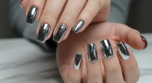Chrome nails with rhinestone accents for a subtle glamorous look