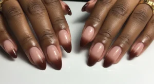 Brown ombre nails on dark skin with smooth gradient effect