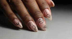 Minimal line art nails on dark skin with nude base