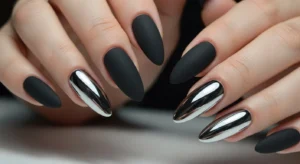 Matte black nails with chrome silver accent nails for contrast