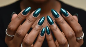 Dark teal fall nails on dark skin with glossy finish