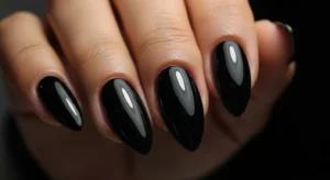 Glossy black almond nails sleek style on dark skin
