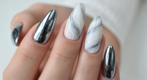 Chrome marble nails with soft swirl design and metallic shine
