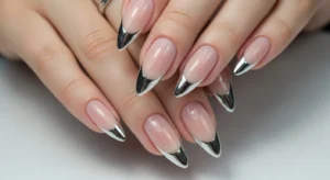 Nude nails with silver chrome French tips in a modern design
