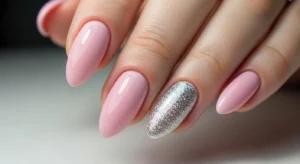 Short pink nails with silver glitter accent design
