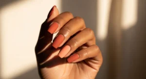 Terracotta and peach nail colors on dark skin