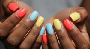 Bright nail colors like coral blue and yellow on dark skin