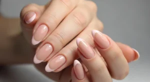 hort nails featuring light pink French tips on a natural base