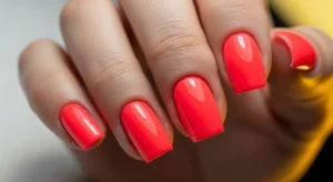 Short nails painted in vibrant neon pink color