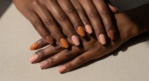 Nude nail ideas for dark skin featuring caramel, beige, and pink nude glossy nail designs