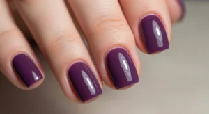 short nails painted single purple shade, glossy finish, minimal style