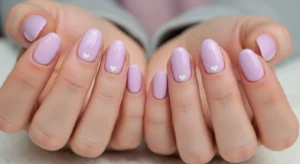 lilac nails with heart design for cute and feminine nail art style