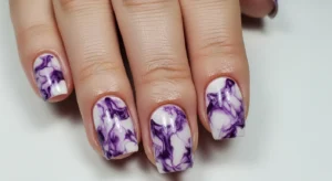 purple marble nails with mixed tones creating unique and artistic nail design