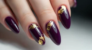purple nails with gold foil accents creating stylish and refined manicure design