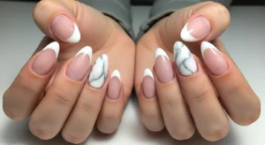 french tip nails with marble accent for stylish textured manicure