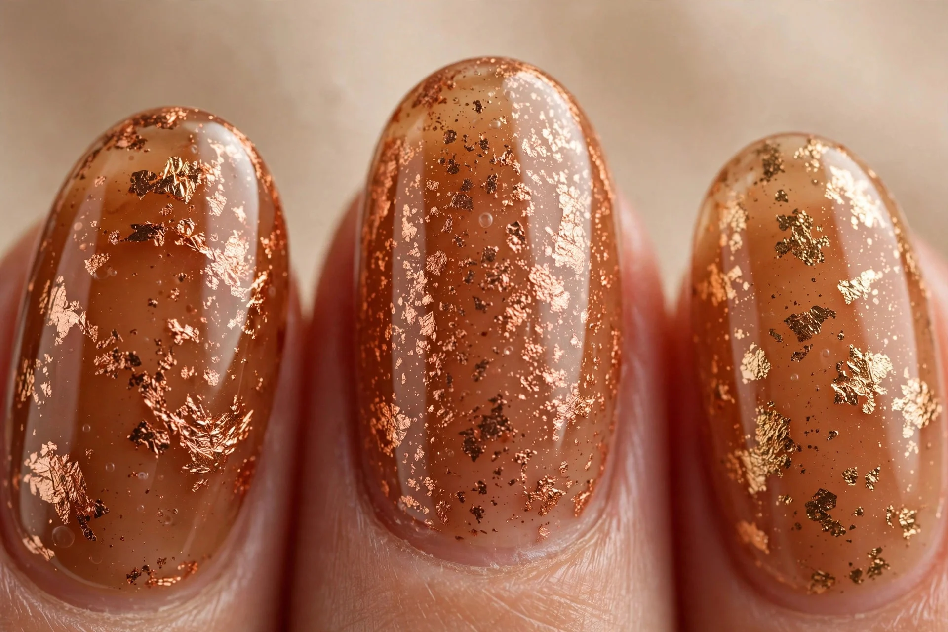 Oval nails in cider gel with copper foil flakes, warm neutral background