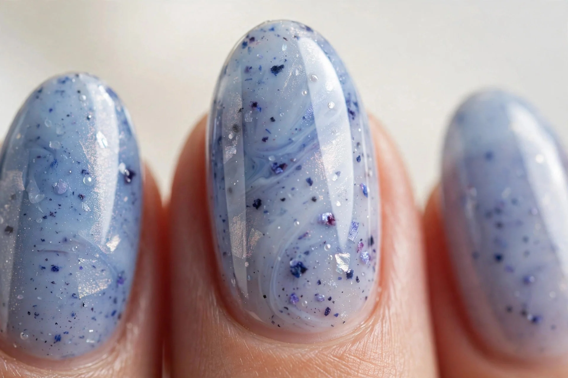 Almond nails with blueberry milk and translucent pearl glaze, glazed finish, light background