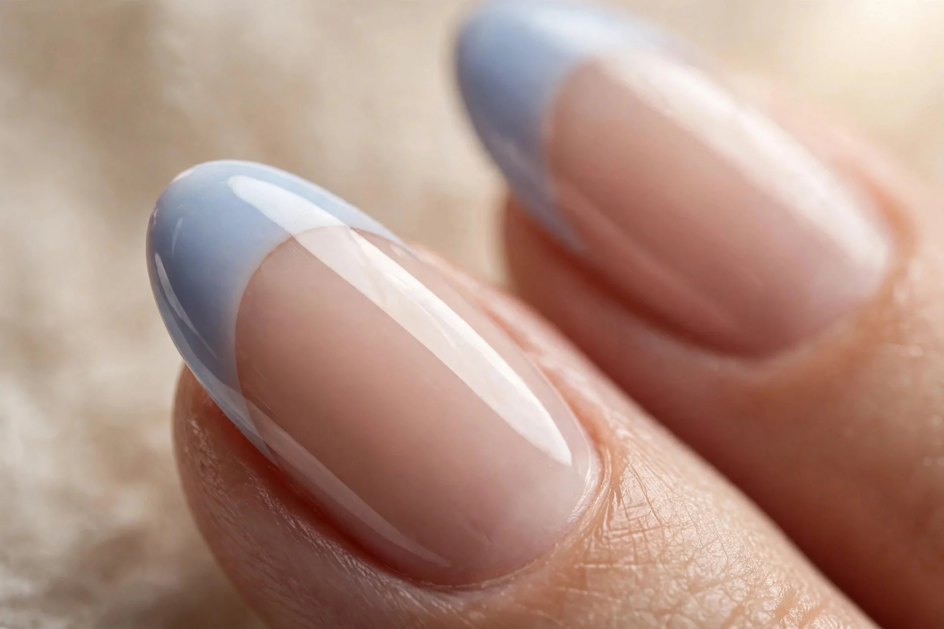 Almond nails with sheer nude base and blueberry milk French tips, glossy, beige background