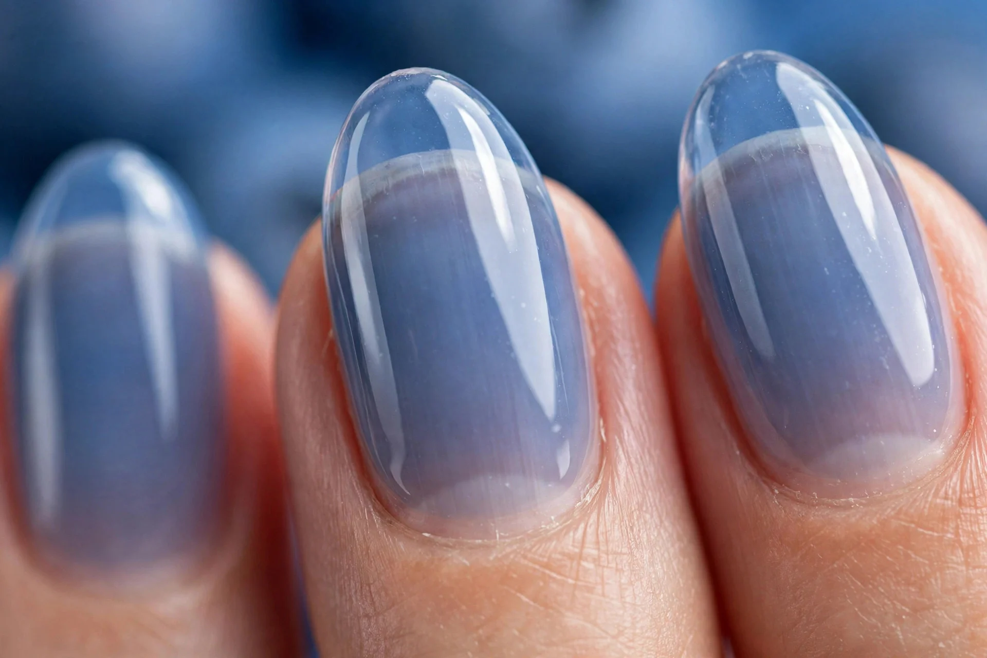 Oval nails with translucent blueberry jelly, natural nail showing through, glossy, blue background