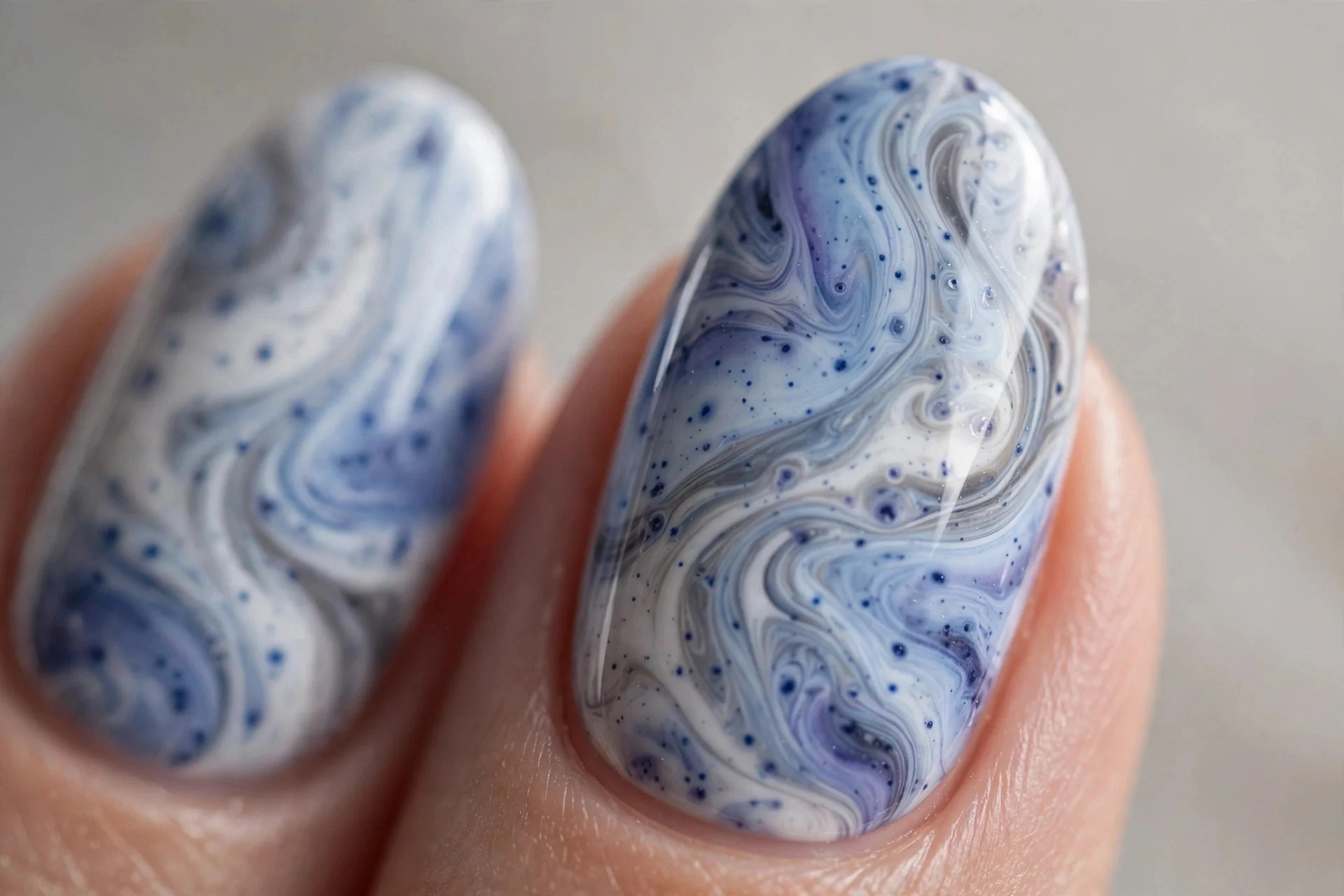 Almond nails with blueberry milk marble swirled with white and gray, glossy, neutral background