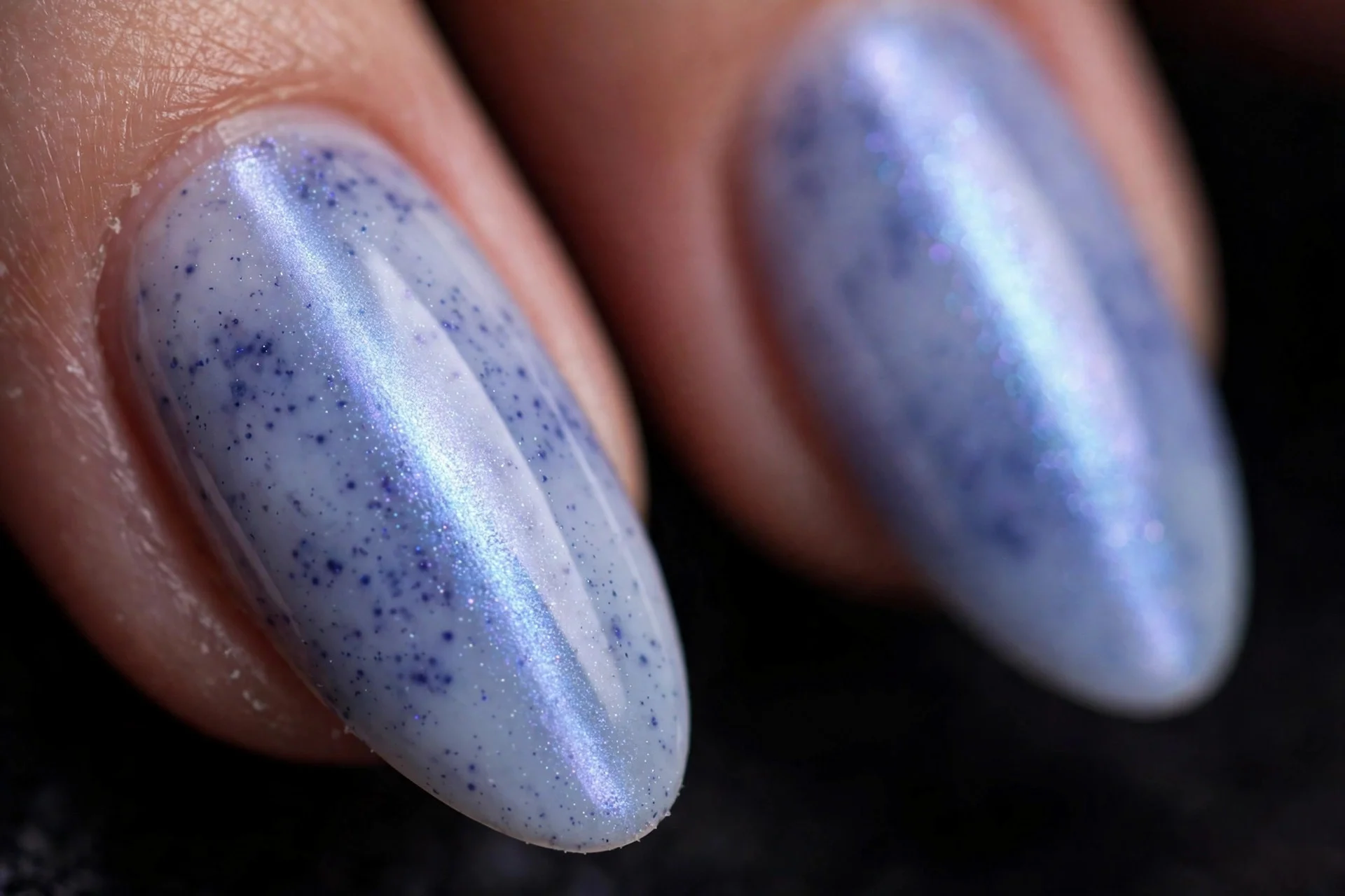 Almond nails with blueberry milk cat eye, diffused magnetic shimmer stripe, dark background