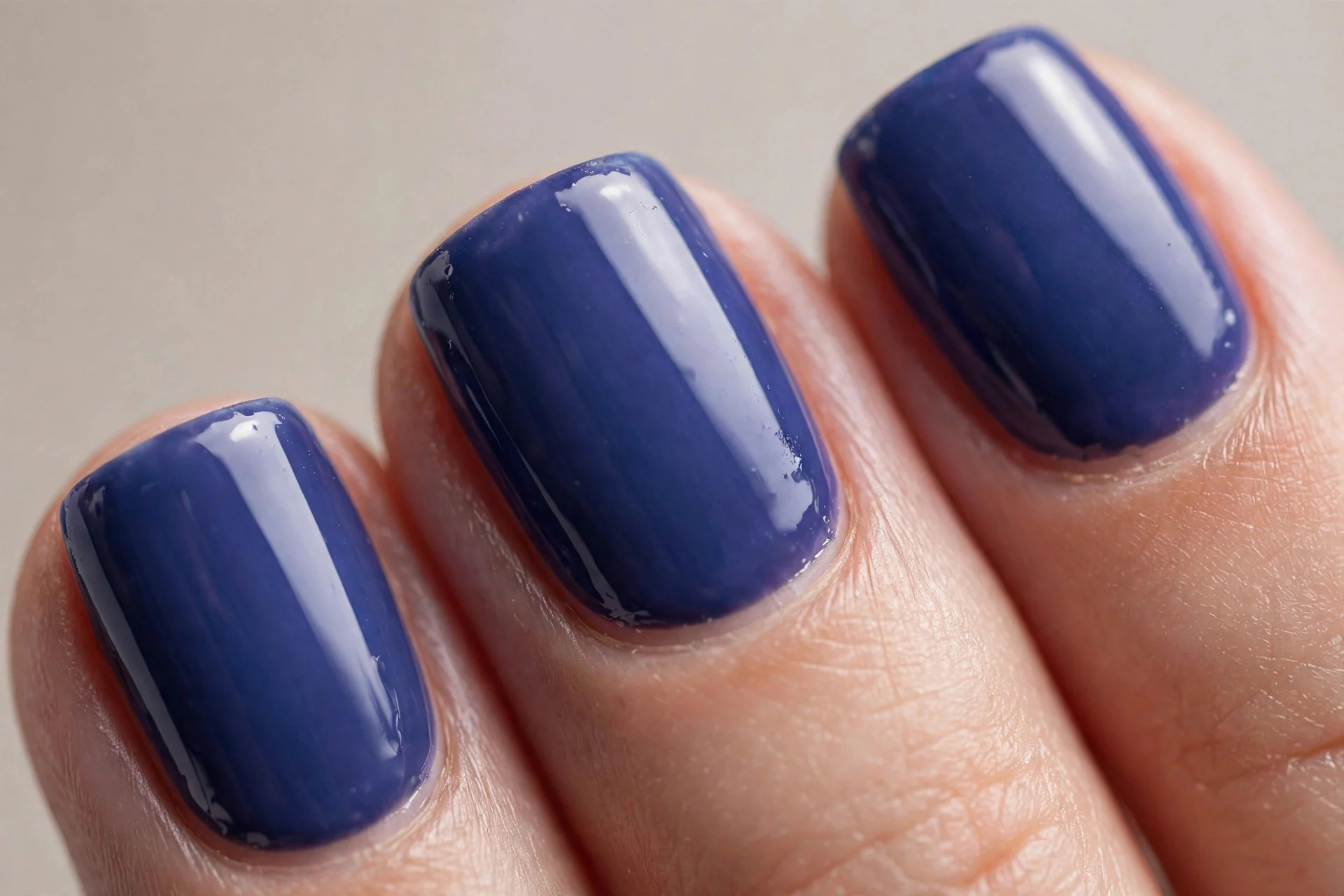 Short square nails with deep saturated blueberry milk, glossy, neutral background