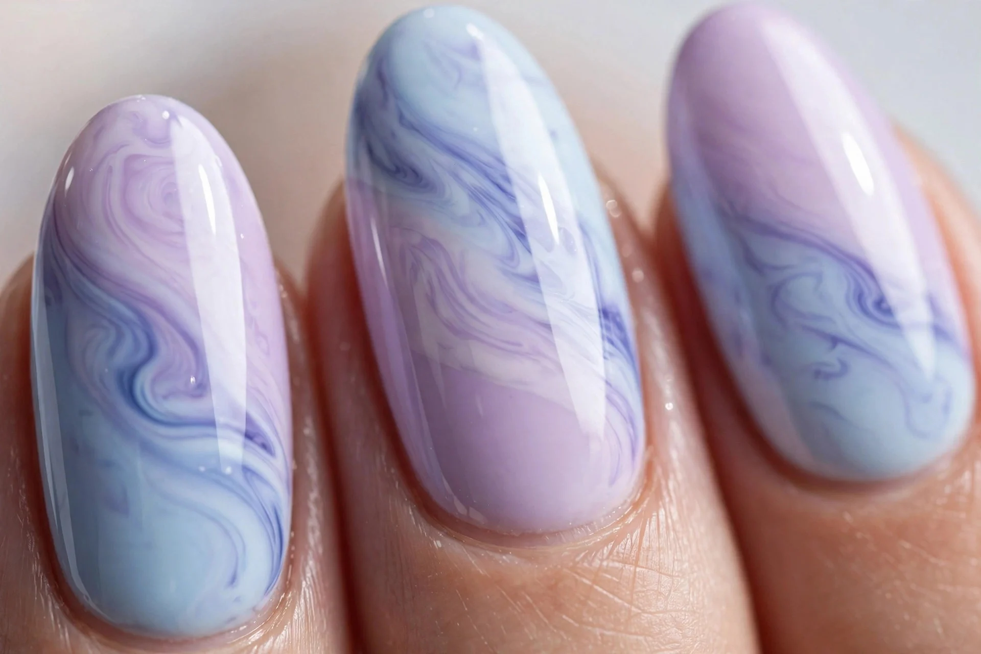 Almond nails alternating blueberry milk and lavender milk, two-tone, glossy, light background