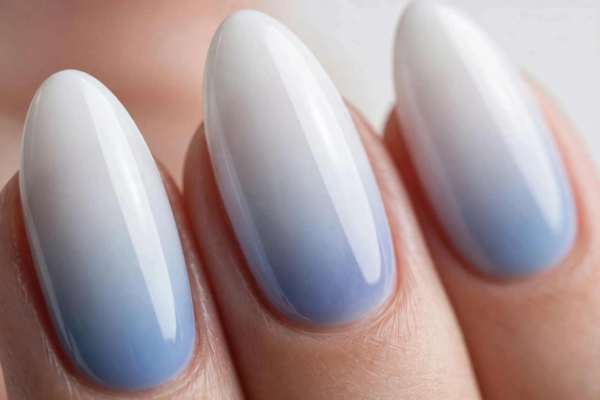 Almond nails with blueberry milk fading to white tips, ombr&eacute;, glossy, light background