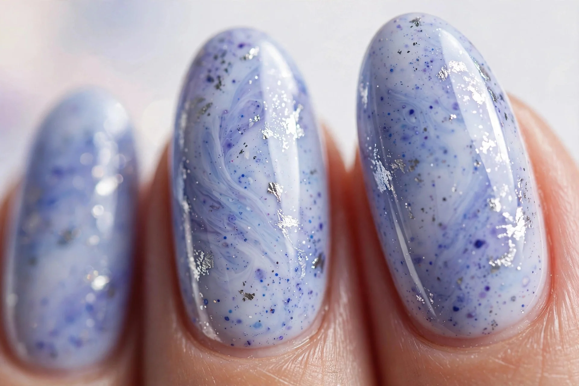 Almond nails with blueberry milk and silver foil flecks, glossy, light background