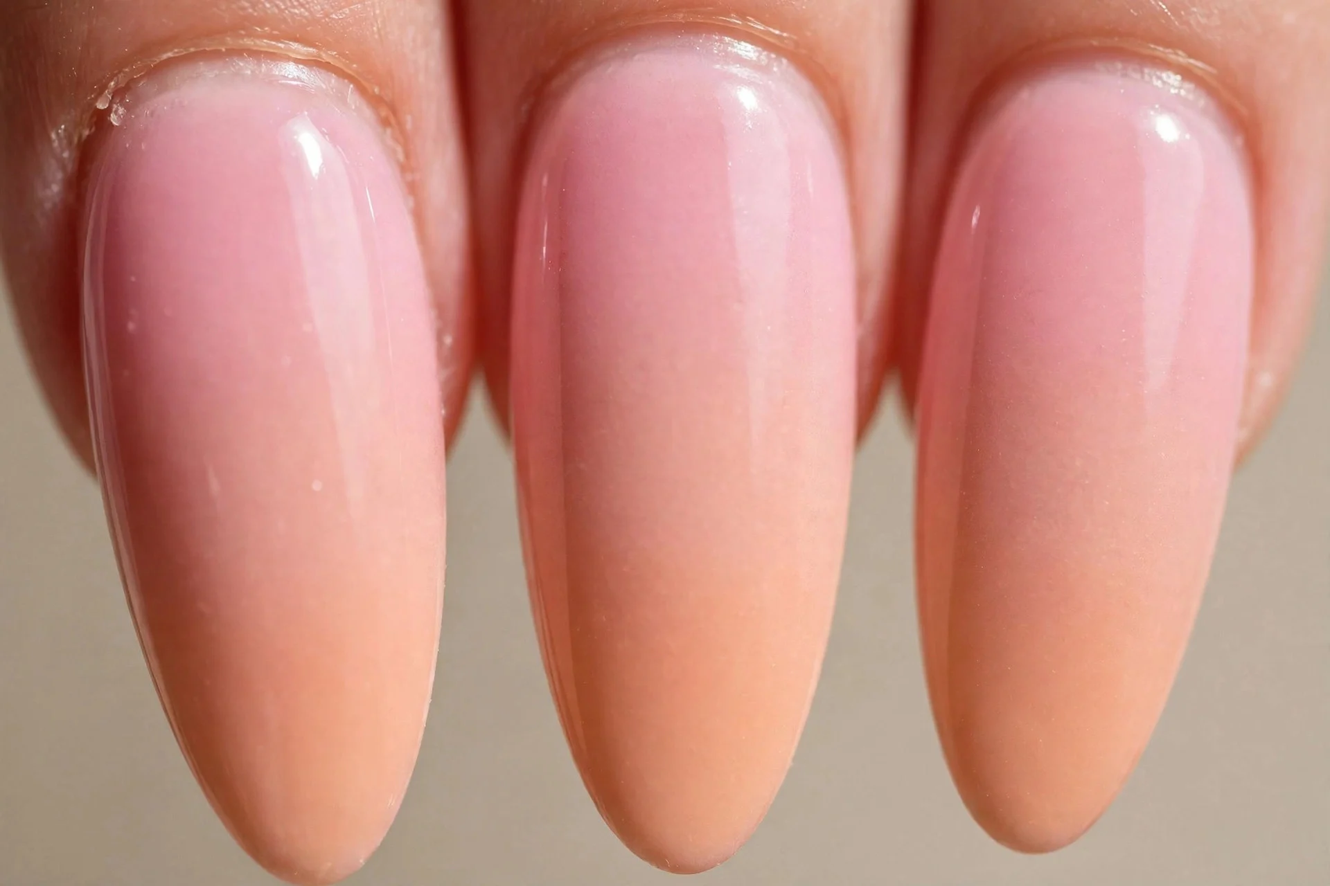 pink-to-peach ombre gel on long almond nails, airbrushed gradient blend