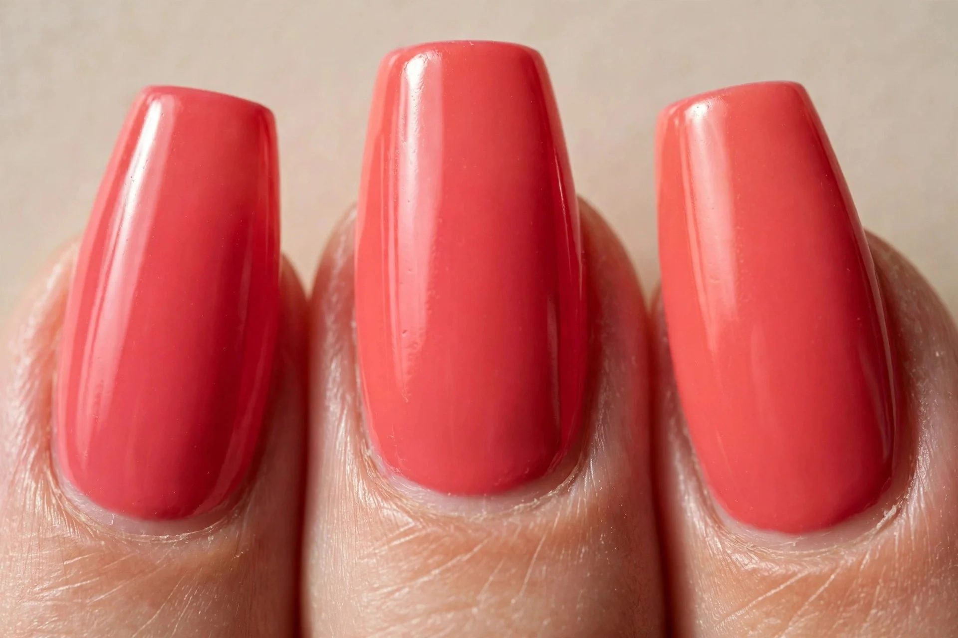 saturated deep coral-pink creme on medium coffin nails, glossy finish