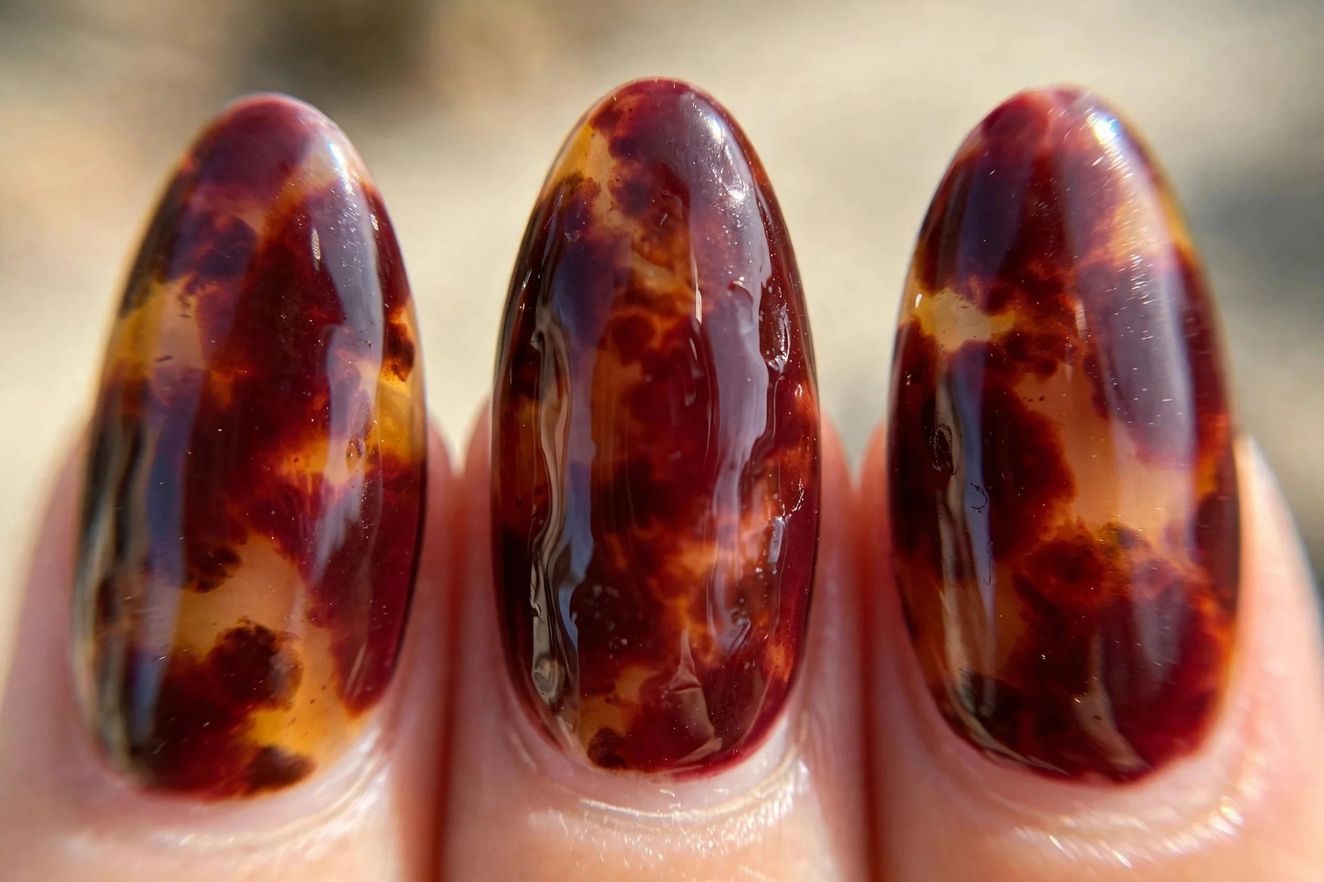 Burgundy tortoiseshell nail art, almond nails, glossy translucent