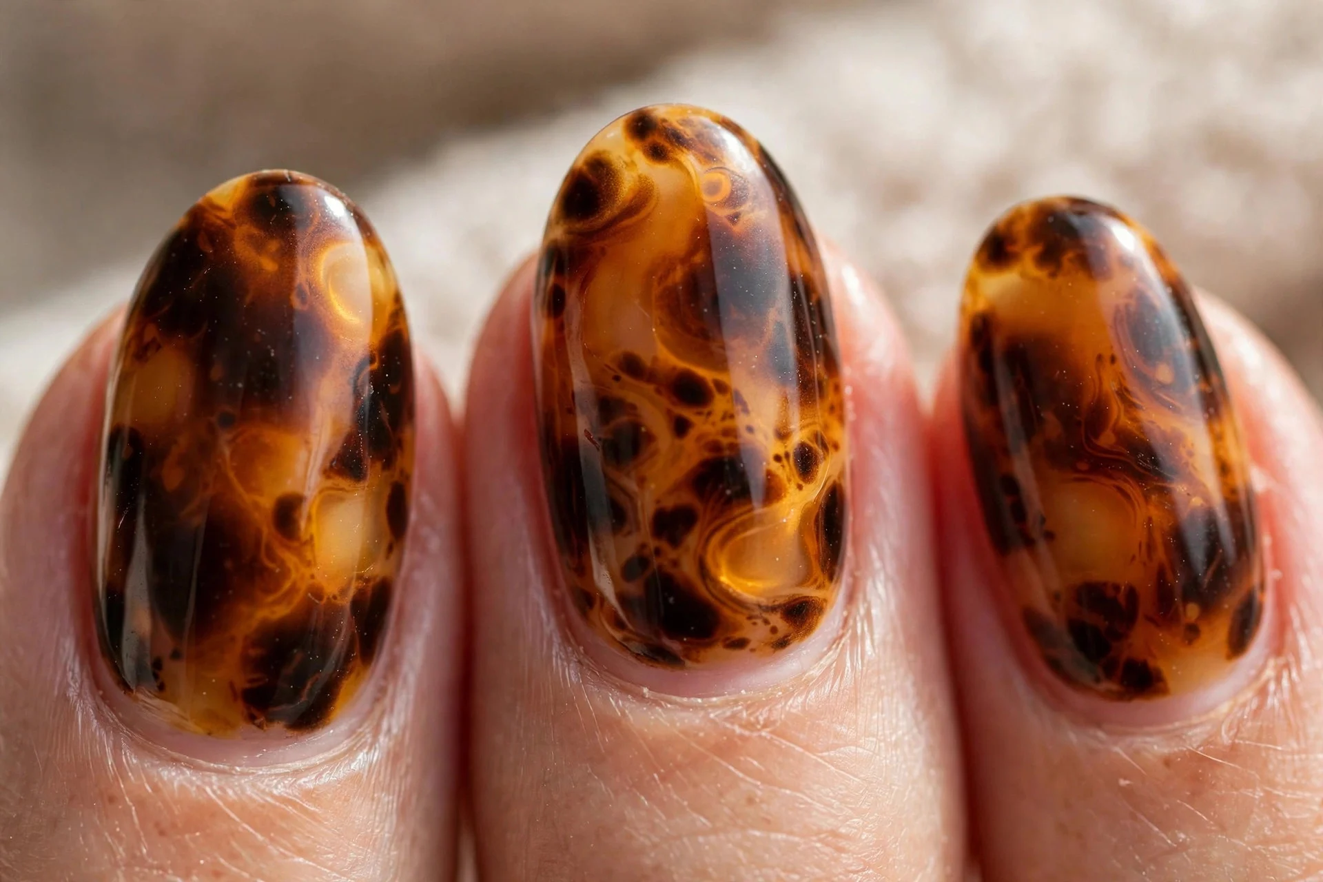 Tortoise shell nail art in caramel, amber and espresso tones.
