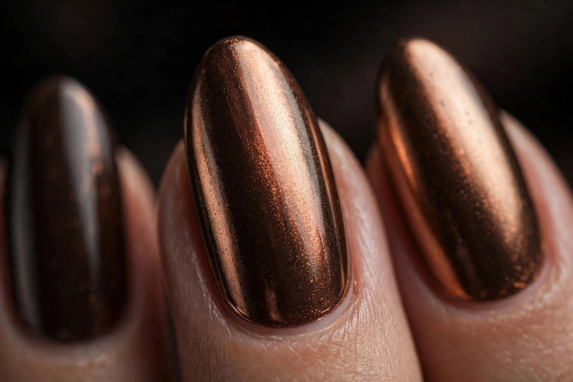 Almond nails with espresso base and cinnamon chrome finish, metallic, dark background
