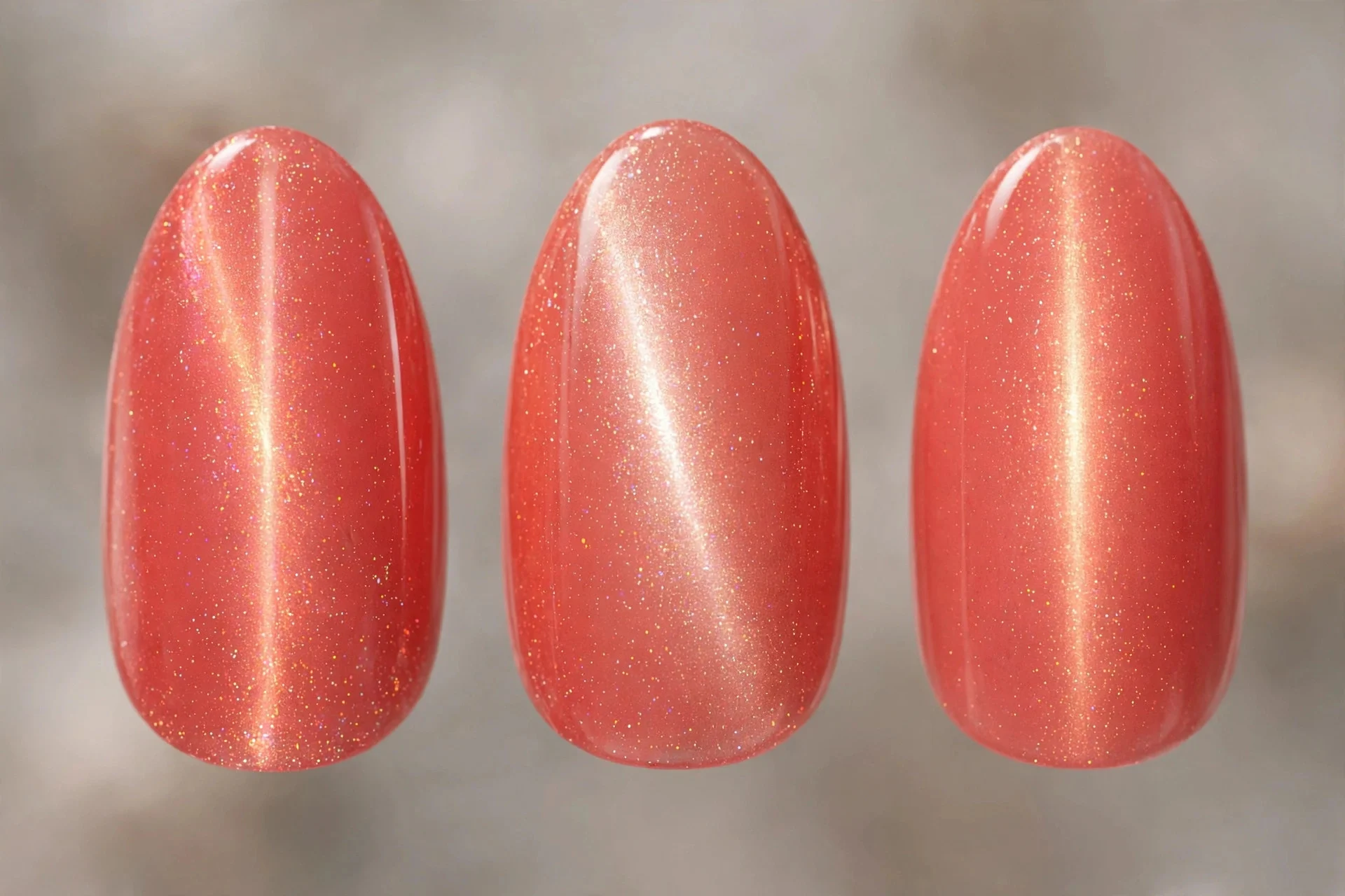 Coral magnetic cat-eye nails with glowing centre line, almond nails