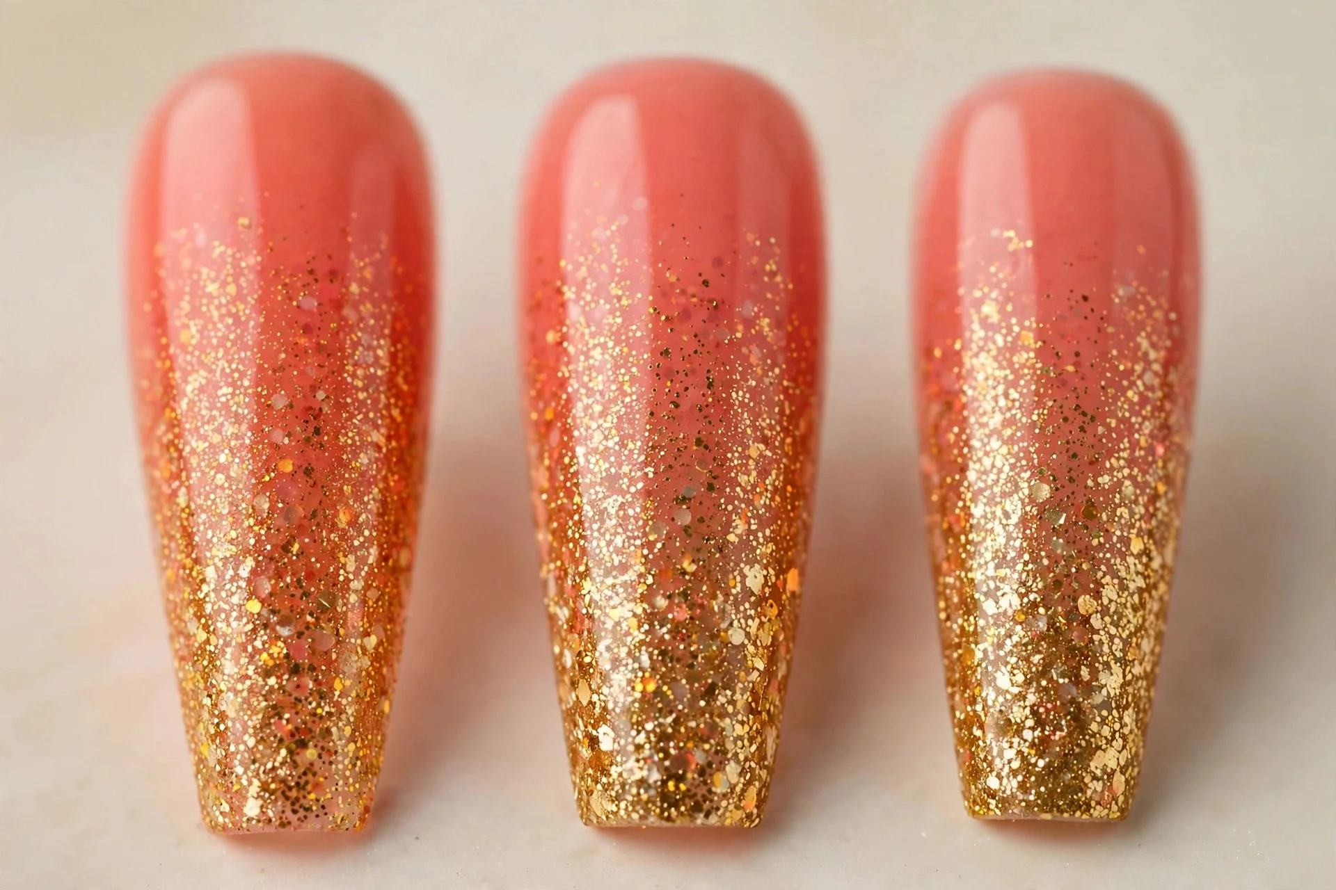 Coral to gold glitter gradient ombr&eacute; nails, long coffin nails