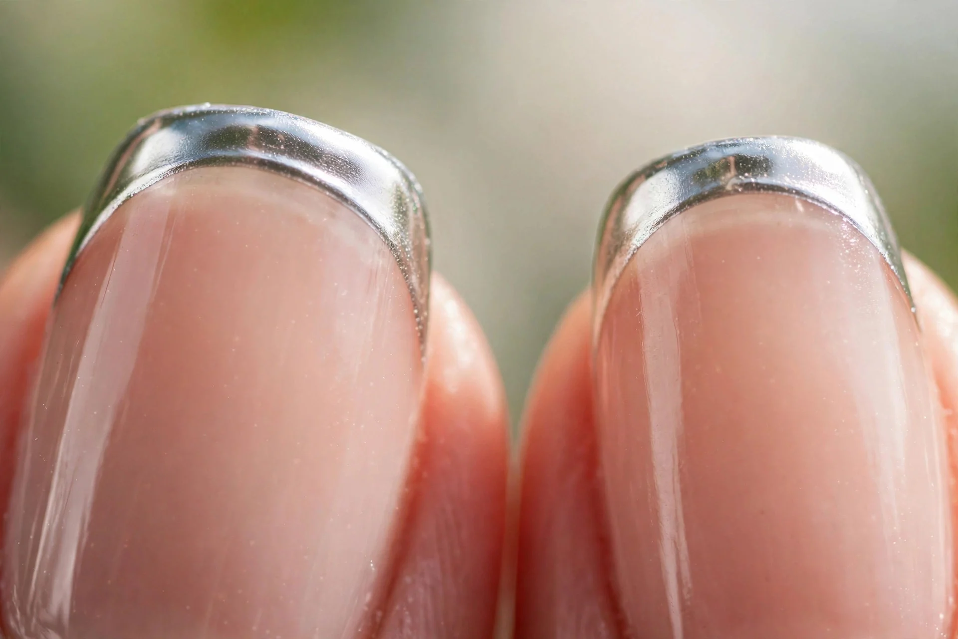 sheer nude nails with metallic silver chrome French tips