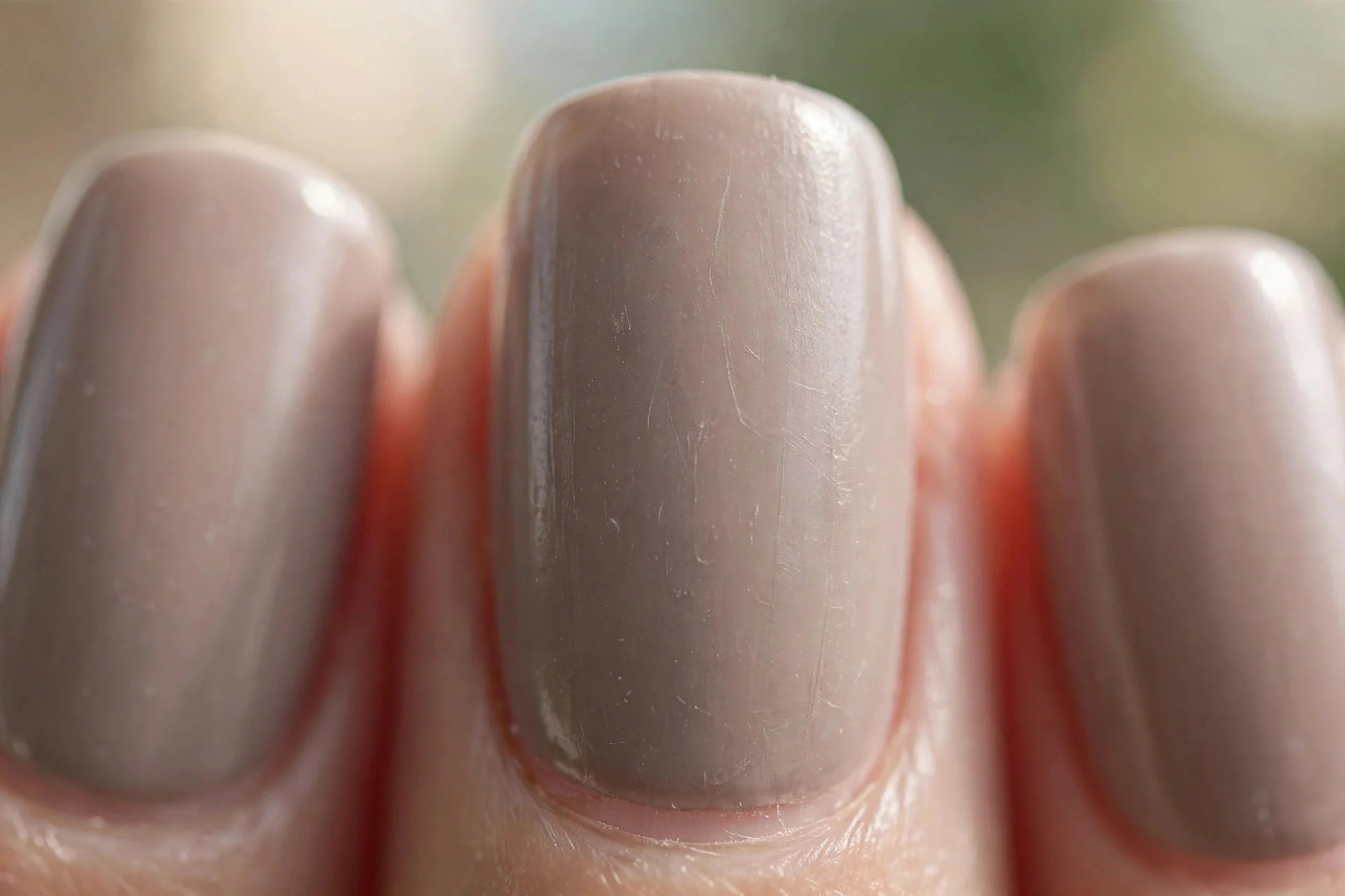 squoval nails in soft taupe polish with a satin finish