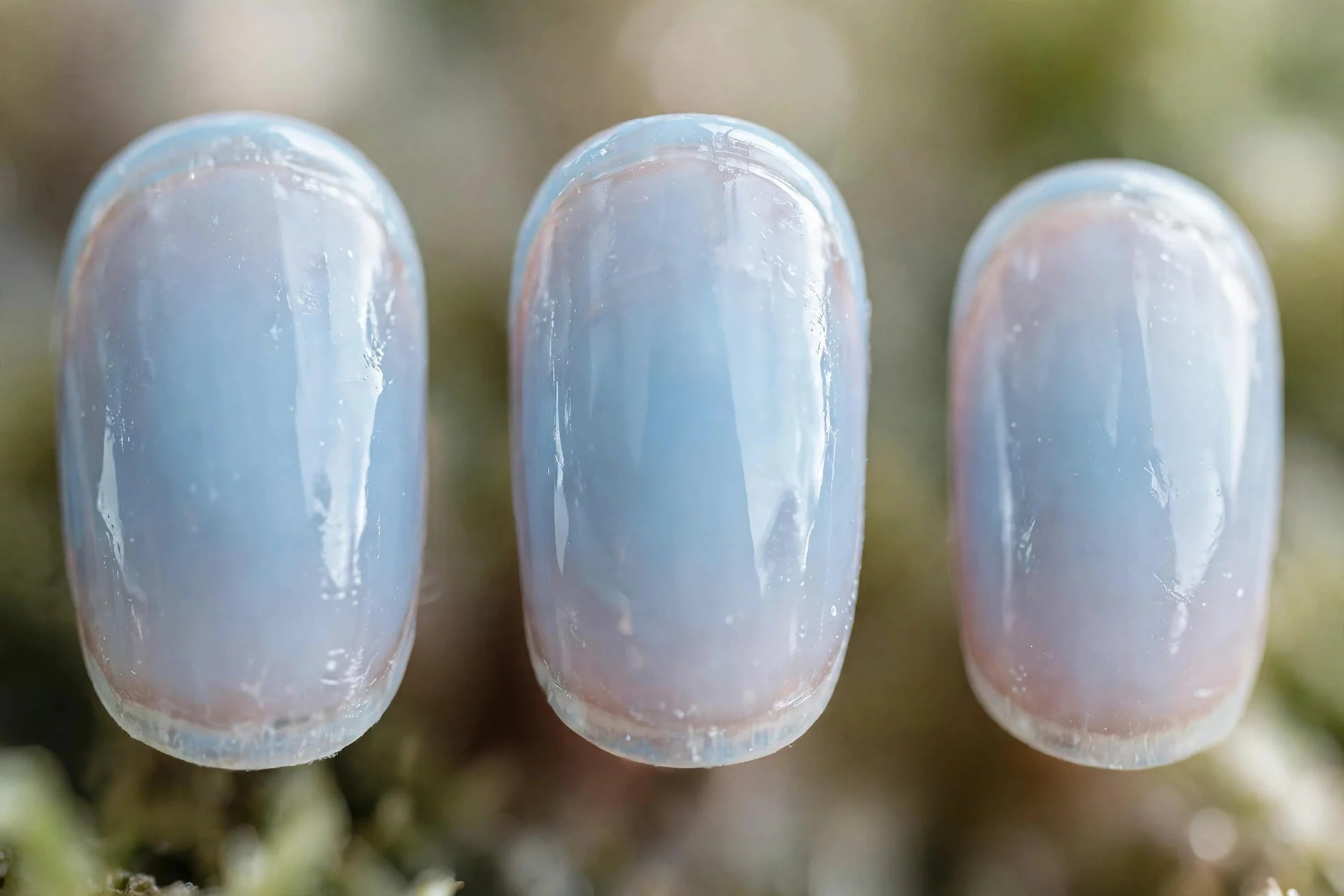 Sheer baby blue translucent polish, short oval nails