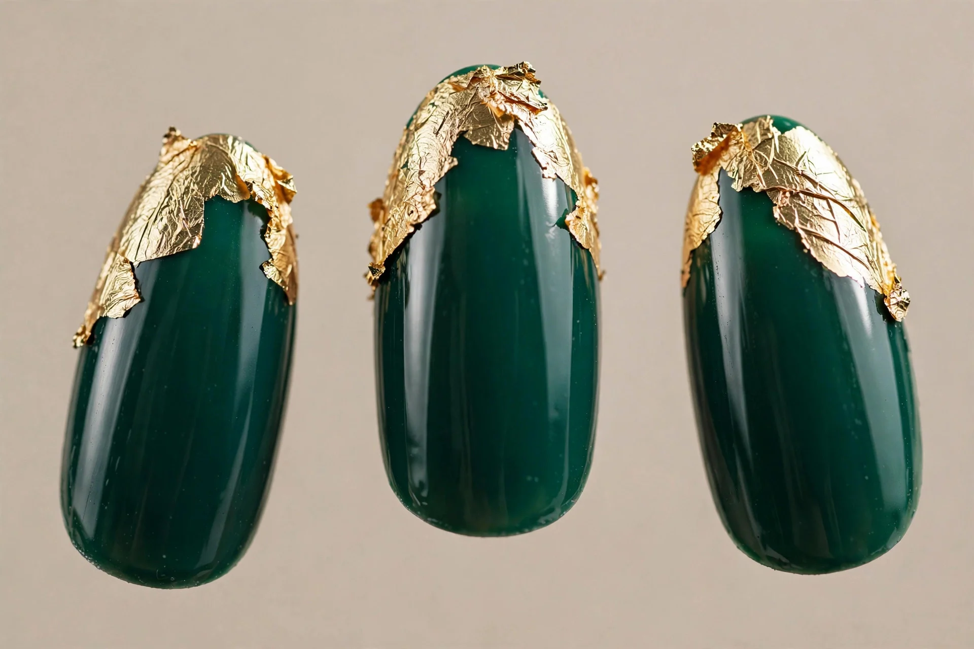 Deep emerald base, gold foil tips, almond nails.