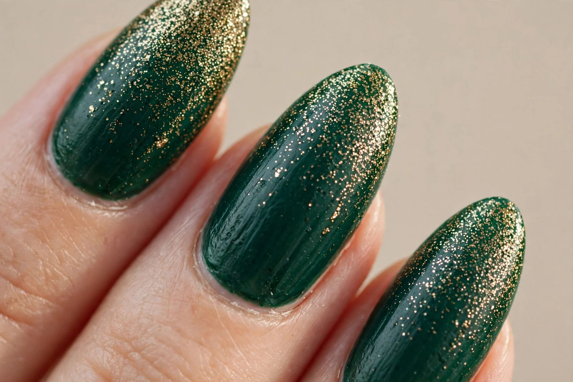 Deep emerald with gold glitter fade, almond.