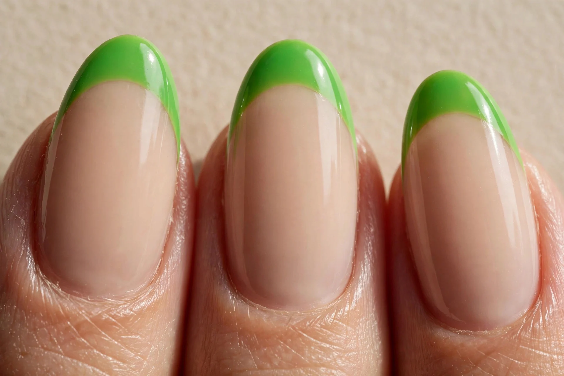 Nude base, lime-bright emerald French tips.