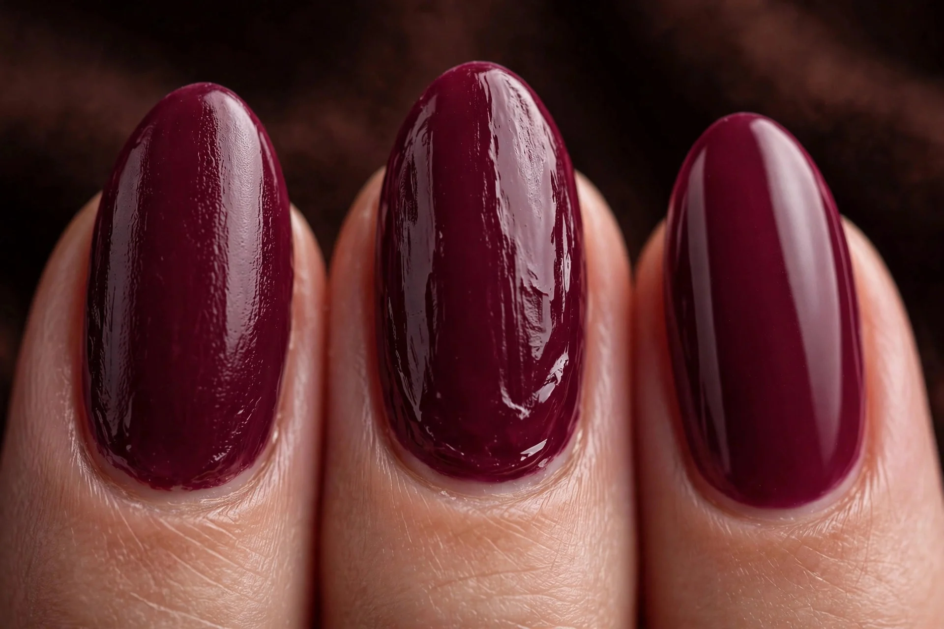 Almond nails in deep berry structured gel, dark warm background