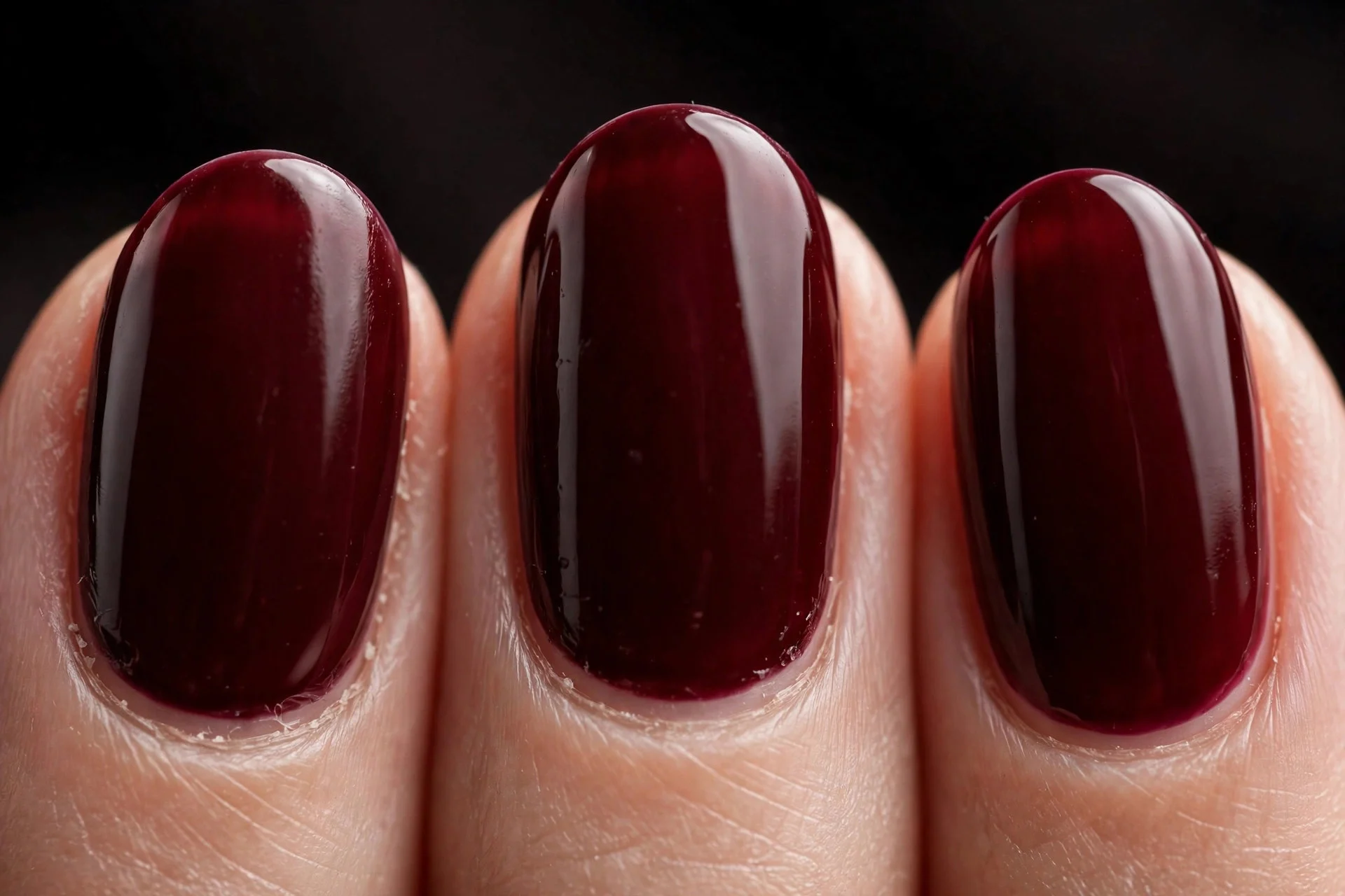 Oval nails in deep oxblood cr&egrave;me gel, dark background