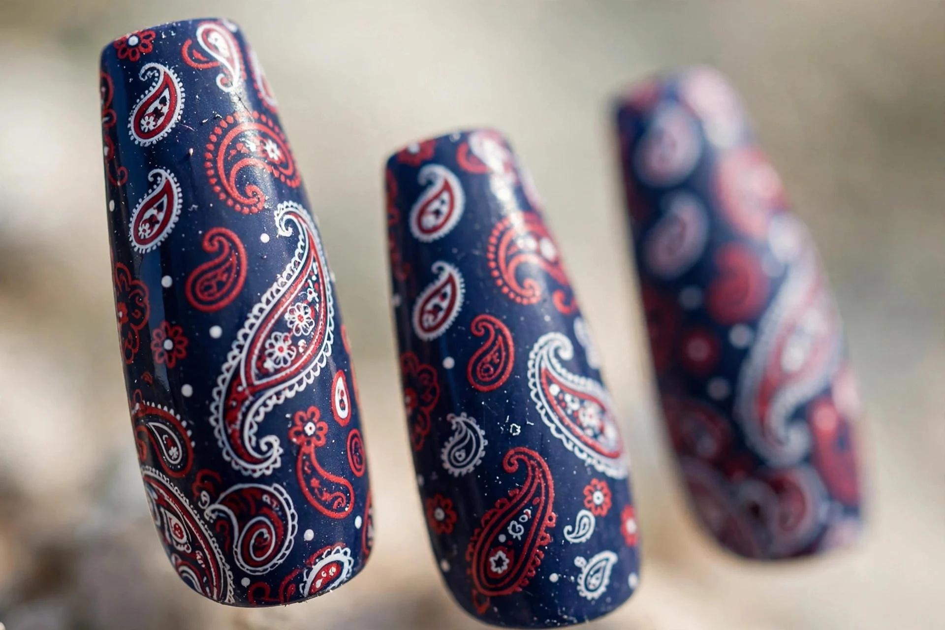 Navy nails with white and red bandana paisley print, coffin nails