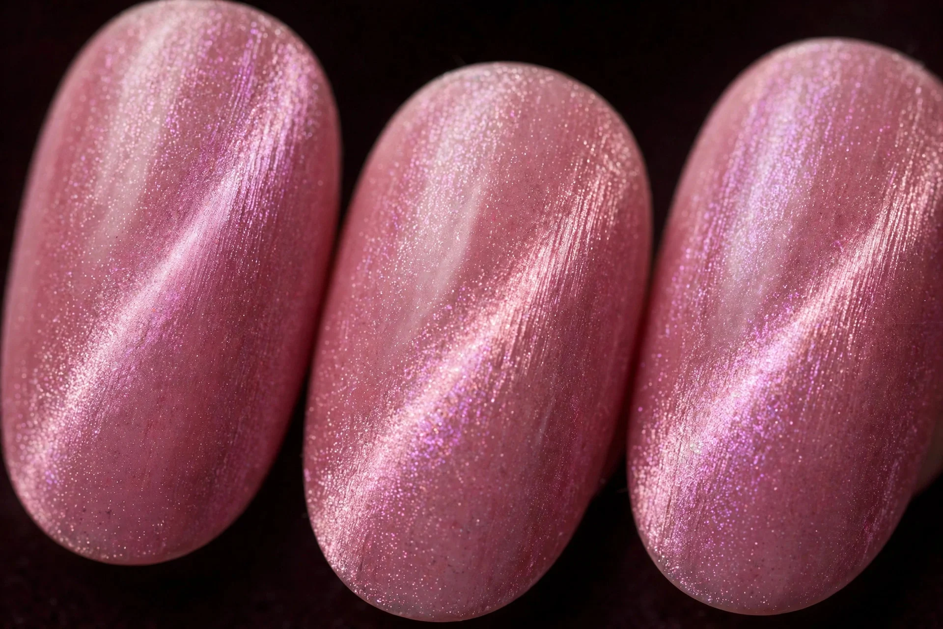 Oval nails with pink velvet magnetic cat-eye shimmer, glossy, dark background
