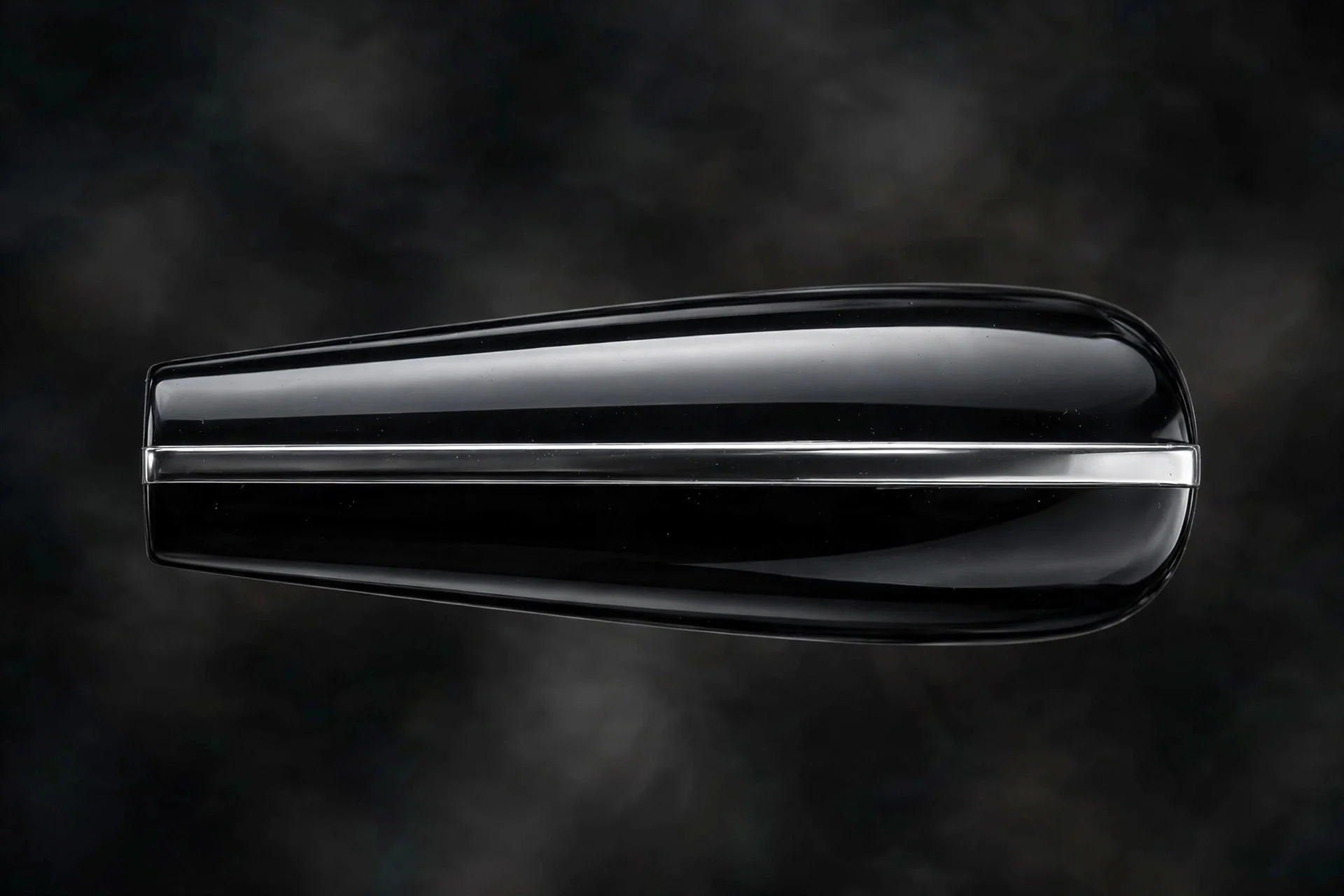 Long coffin fingernail in black mirror chrome with horizontal silver chrome bar detail, dark background